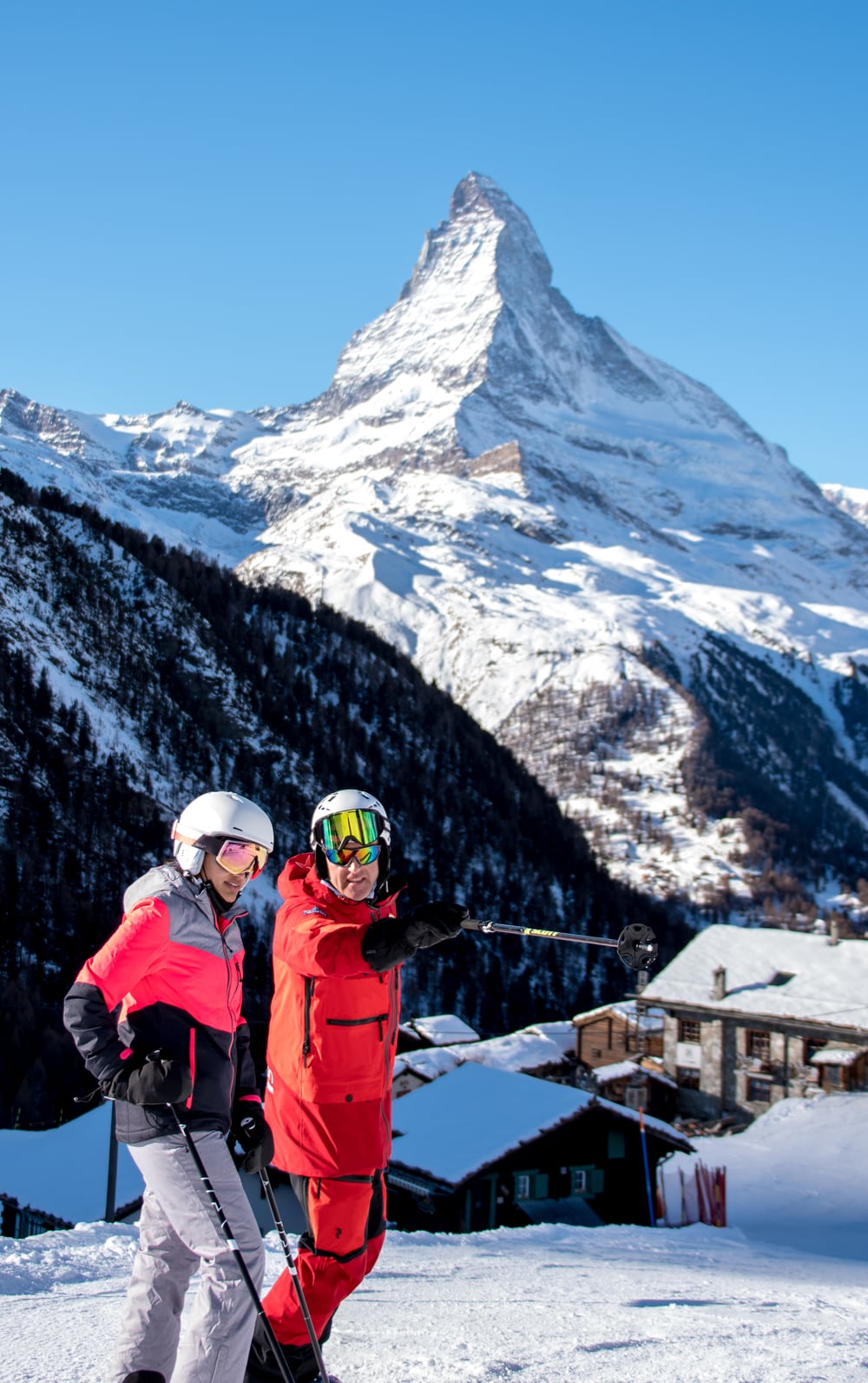 Two skiers with the Matterhorn behind them in Zermatt